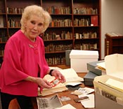 Marie McMillian and Mary Palevsky review Ms. McMillian's donation of test site documents in UNLV Special Collections