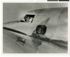 Photograph of Howard Hughes in the cockpit of a Lockheed-14 plane, New York, July 10, 1938