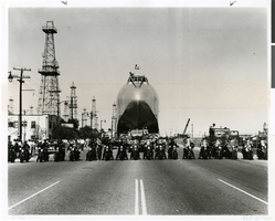 Photograph of police escorting the fuselage of Hughes Flying Boat, San Pedro, California, June 15, 1946