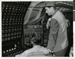 Photograph of Howard Hughes checking the Hughes Flying Boat, Terminal Island, Los Angeles Harbor, November 1, 1947