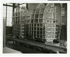 Photograph of an unidentified man and an airplane part, circa 1920s-1950s