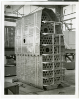 Photograph of an unidentified man and an airplane part, circa 1920s-1950s