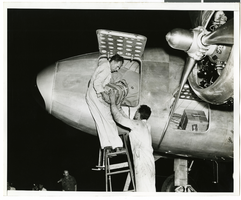 Photograph of mechanics with the Lockheed 14 aircraft, July 10, 1938