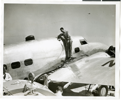 Photograph of mechanics with the Lockheed 14 aircraft, July 10, 1938