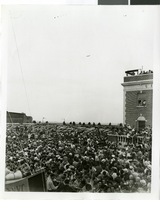 Photograph of a crowd of people awaiting the arrival of Howard Hughes, New York, July 14, 1938