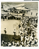 Photograph of a crowd watching Howard Hughes boarding an airliner, circa July 1938