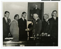 Photograph of Howard Hughes and other men, 1938