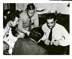 Photograph of Howard Hughes talking to newspapermen, Los Angeles, August 1, 1938