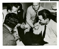 Photograph of Howard Hughes talking to newspapermen, Los Angeles, August 1, 1938