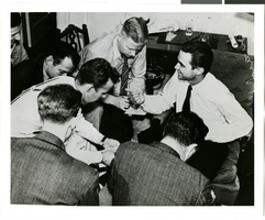 Photograph of Howard Hughes talking to newspapermen, Los Angeles, August 1, 1938