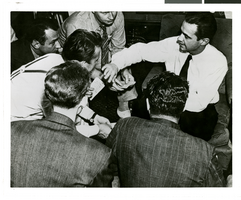 Photograph of Howard Hughes talking to newspapermen, Los Angeles, August 1, 1938