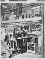 Photograph of airplanes being built by Howard Hughes and workers, circa 1943