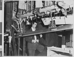 Photograph of airplanes being built by Howard Hughes and workers, circa 1943