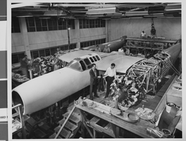 Photograph of airplanes being built by Howard Hughes and workers, circa 1943