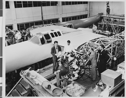 Photograph of airplanes being built by Howard Hughes and workers, circa 1943