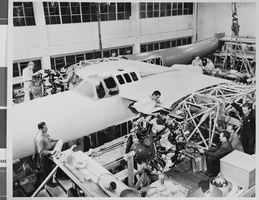 Photograph of airplanes being built by Howard Hughes and workers, circa 1943