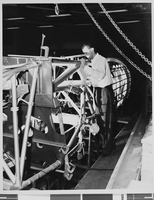 Photograph of airplanes being built by Howard Hughes and workers, circa 1943
