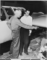 Photograph of airplanes being built by Howard Hughes and workers, circa 1943