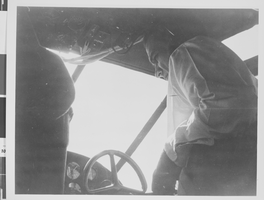 Photograph of Howard Hughes flying a plane, circa 1944