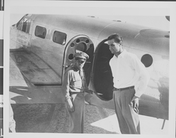Photograph of Howard Hughes flying a plane, circa 1944
