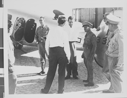 Photograph of Howard Hughes flying a plane, circa 1944