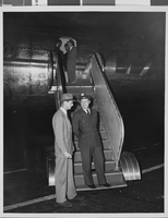 Photograph of Howard Hughes flying a plane, circa 1944