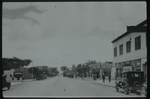 Black and white view of the downtown area of Las Vegas. White Cross Drug Store is visible in the background.