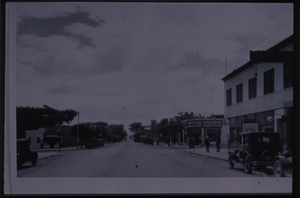 Black and white view of the downtown area of Las Vegas. White Cross Drug Store is visible in the background.