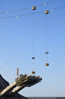 Photograph of ironworkers being transported in manbaskets during Mike O'Callaghan-Pat Tillman Memorial Bridge construction, April 29, 2009