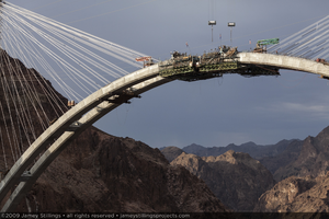 Photograph of the arch segments for the Mike O'Callaghan-Pat Tillman Memorial Bridge between Nevada and Arizona nearly meeting, July 2, 2009