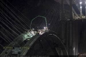 Photograph of the final concrete pour forming the keystone of the arch for the Mike O'Callaghan-Pat Tillman Memorial Bridge between Nevada and Arizona, August 10, 2009