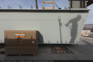 Photograph of a tub girder, tool box, and an ironworker shadow's during construction of the Mike O'Callaghan-Pat Tillman Memorial Bridge, Nevada border, February 2, 2010