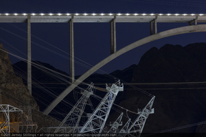 Photograph showing a partial side view of the Mike O'Callaghan-Pat Tillman Memorial Bridge near power lines and towers at Hoover Dam, January 13, 2011