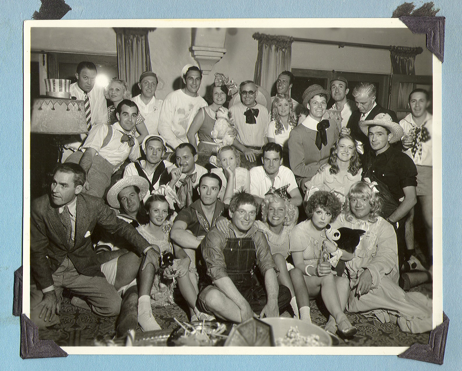 Group photo taken indoors. Many are in costume. Not at the ranch: photographic print