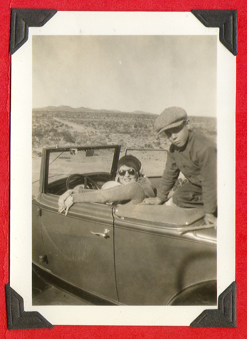Clara Bow Bell in driver's seat of car-unidentified child: photographic print