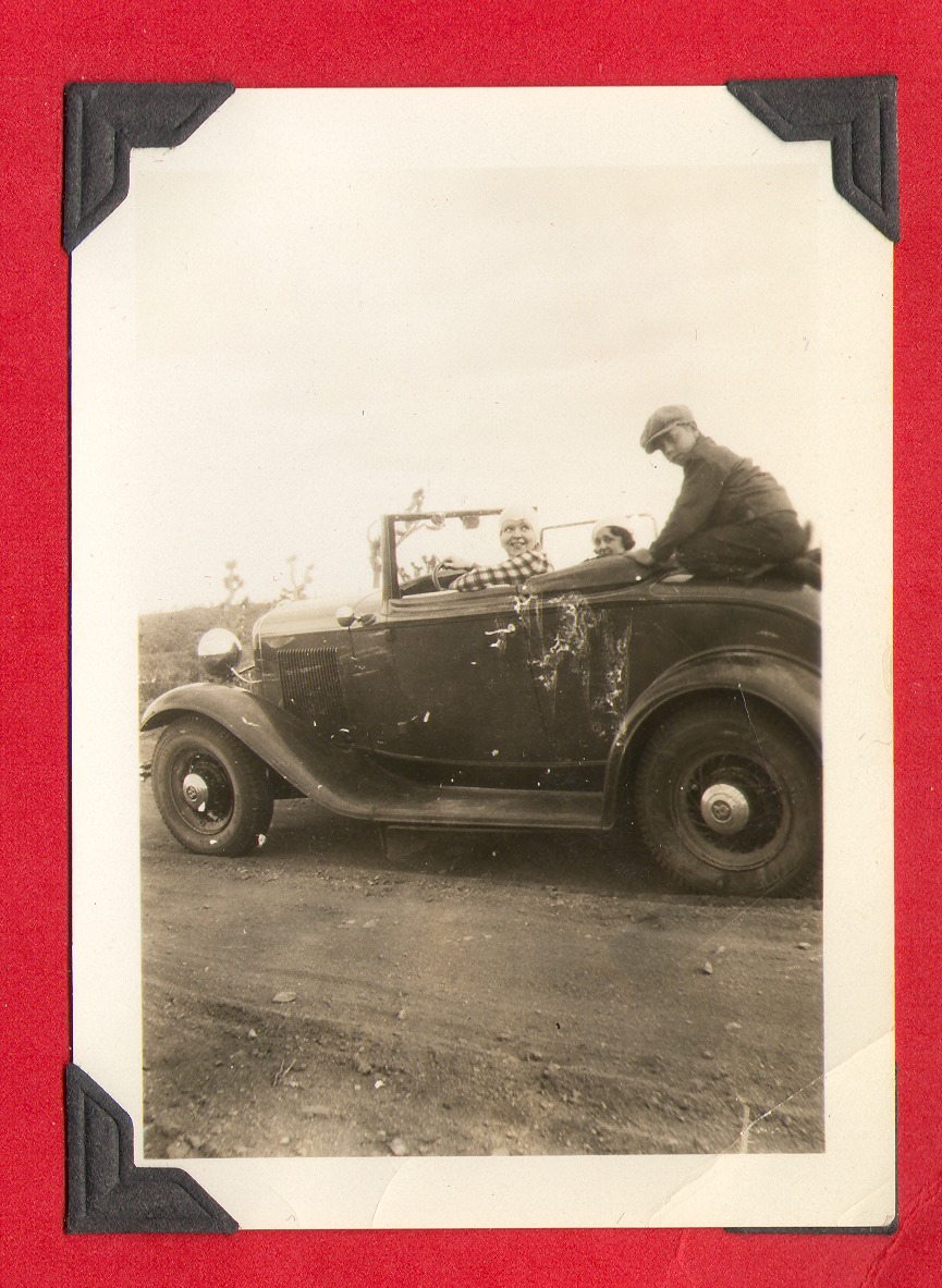 Clara Bow Bell in driver's seat with unidentified woman and child: photographic print