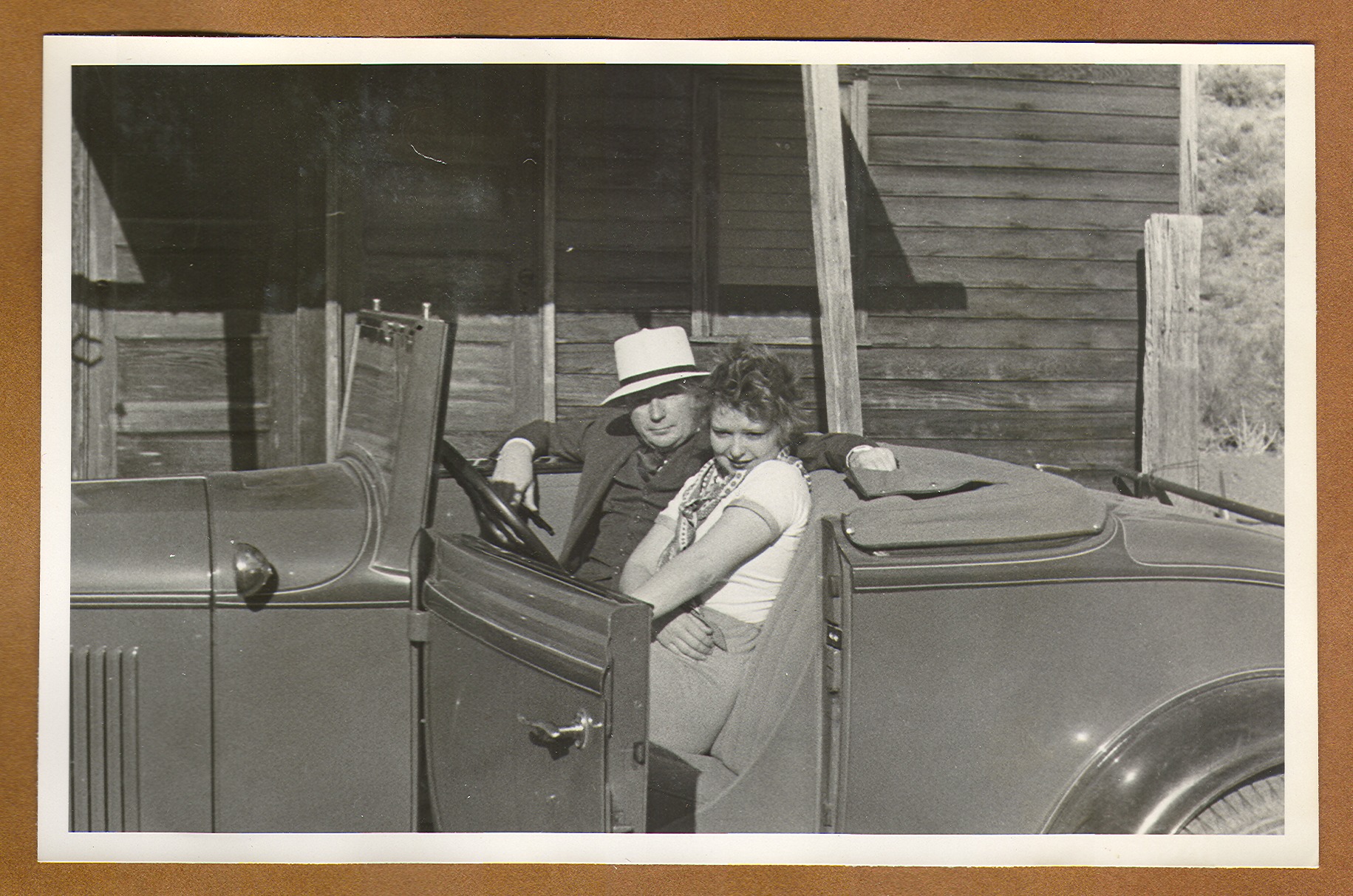 Clara Bow Bell and unidentified man in a convertible: photographic print