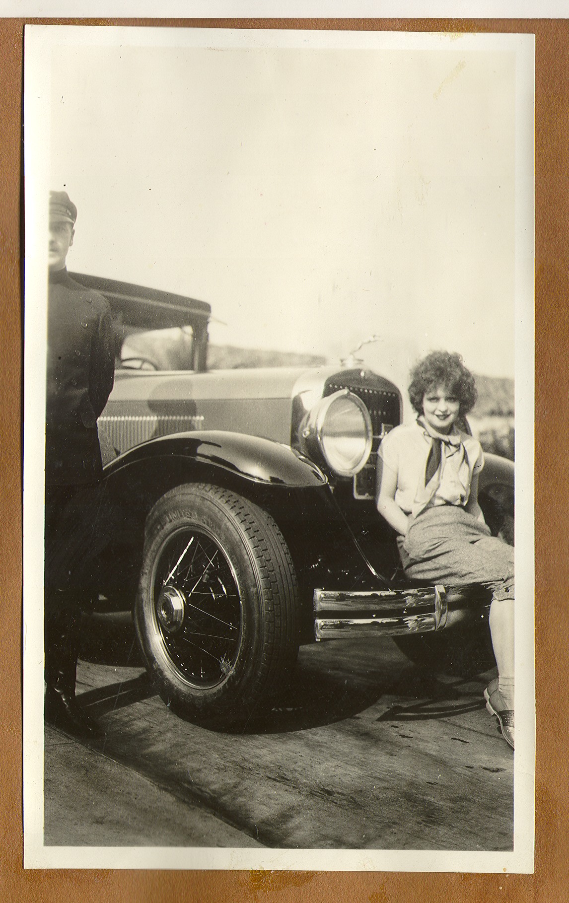 Clara Bell Bow seated on the front bumper of her Rolls Royce: black-and-white photographs