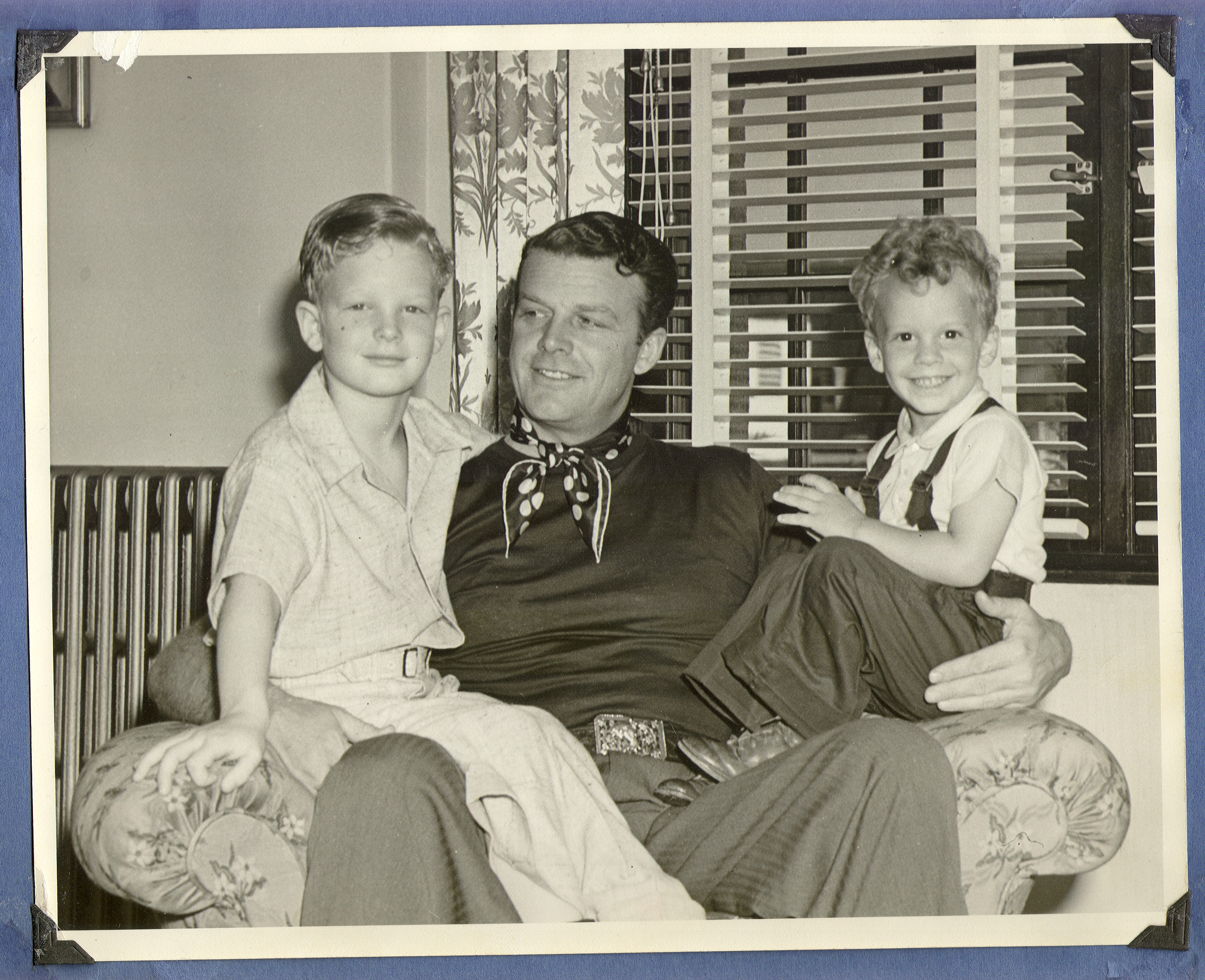 Rex Bell holding Rex Jr. (left) and George in the game room at the ranch: photographic print