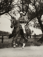 Rex Bell on horseback: photographic print