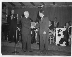 Two men at unknown event shaking hands