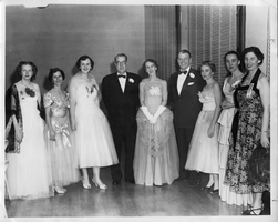 Formal event: Beta Sigma Phi attendants with Govenor.  Left to right:  Anna Ruth Berning, Dorothy Crosby, Phyllis Berning, Gov. Russell, Mrs. Russell, Lt. Gov. Bell, Jean Shaughnessy, Carrie Kelso, Genevieve Shoe. Copyright notice on back of image: Fendrich Studio, Box 360, Carson City, NV Phone 109W