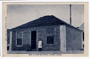 Postcard of  a girl in front of the Bottle House, Goldfield (Nev.), 1900-1925