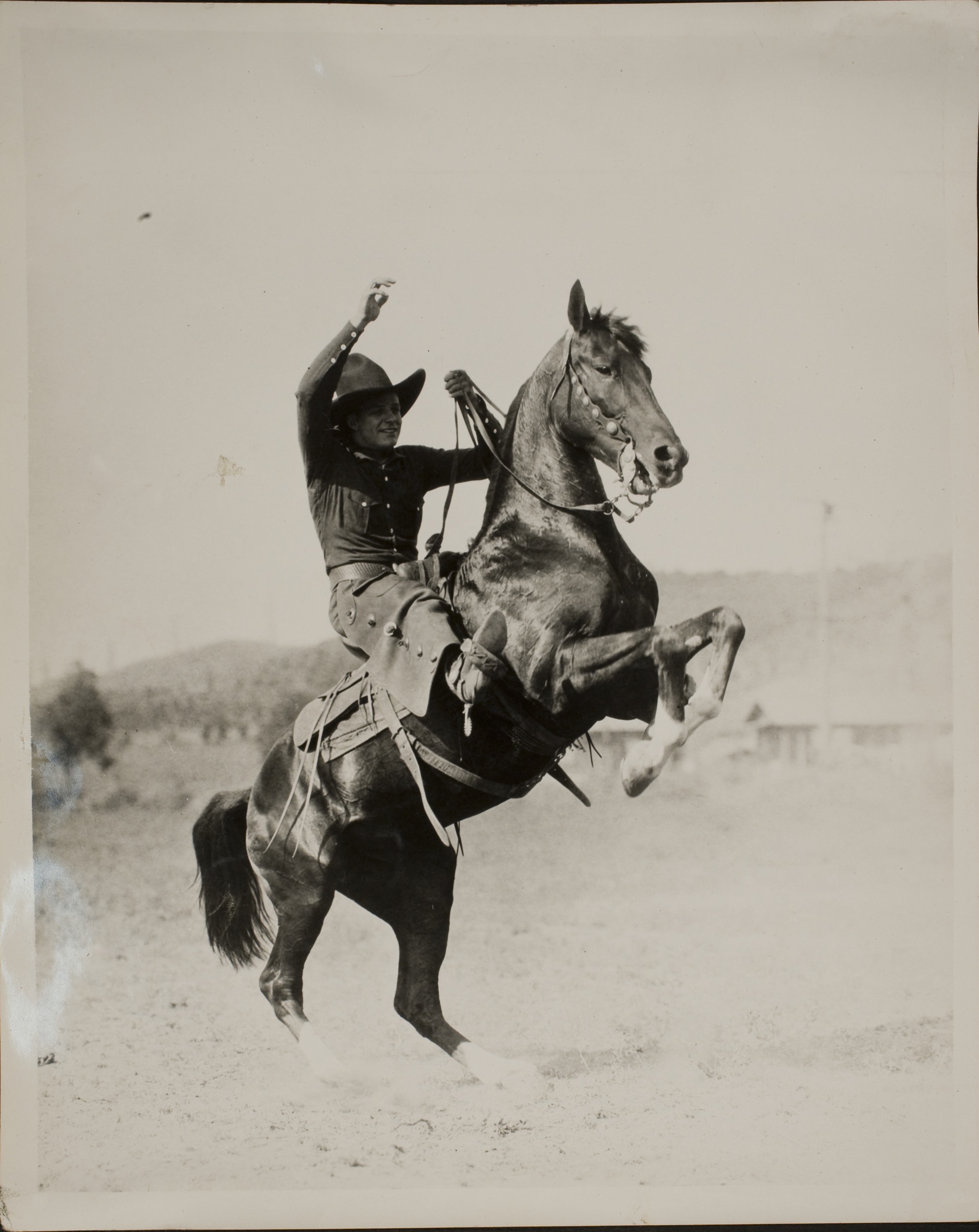 Rex Bell riding on a horse: photographic print