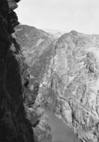 Film transparency of a rigger working on and scaling a canyon wall, Hoover Dam, April 20, 1932