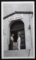 Photograph of two men at entrance of Boulder City, Nevada, post office, circa 1930s
