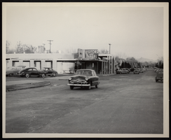 Photograph of automobiles outside of Visitors Bureau, Boulder City, Nevada, circa 1933-1940