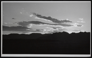 Photograph of sunset against the mountains in the desert, Southwest United States, circa 1930s-1950s
