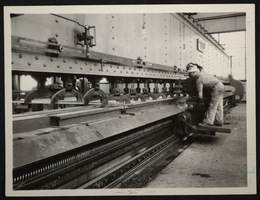 Photograph of a man in a factory, May 29, 1933