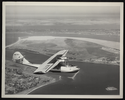 Photograph of an airplane in flight, circa 1960